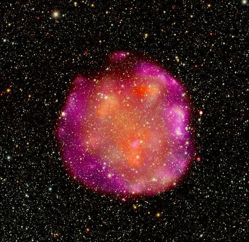 Born after a violent explosion of a star, this cosmic gourd is the supernova remnant G272.2-03.2. X-ray observations (orange and magenta) from Chandra provide evidence that G272 is the result of a Type Ia supernova explosion, where a white dwarf star pulls material from a companion star until it triggers a thermonuclear explosion and obliterates the star. The inside of the “pumpkin” is superheated gas that is filling the space cleared out by the explosion as it moves outward.
Credit: X-ray: NASA/CXC/SA0; Optical: NOIRLab/DECaPS2; Image Processing: NASA/CXC/SAO/L. Frattare