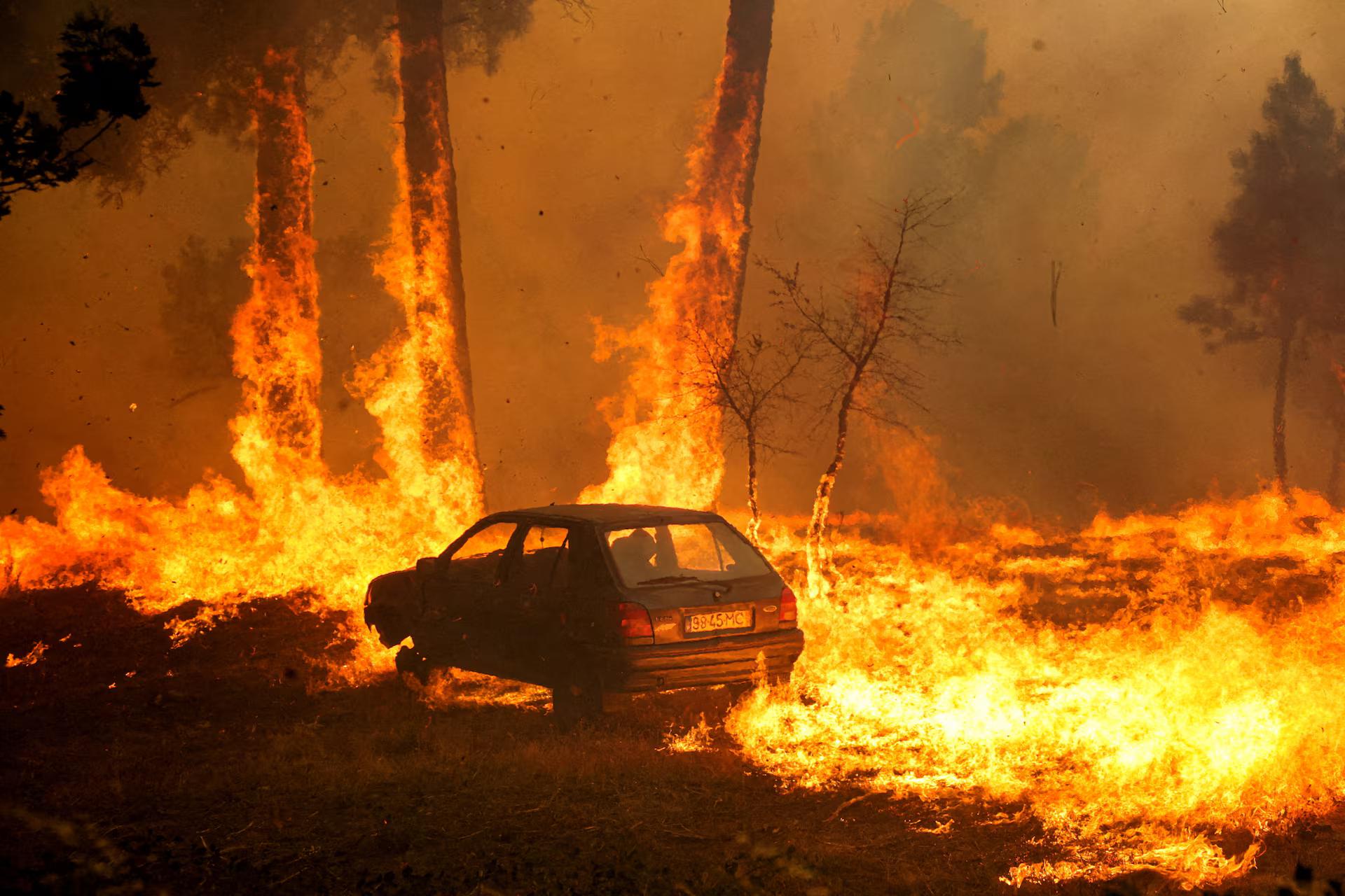 A car burns during the wildfire, in Meda, Portugal.