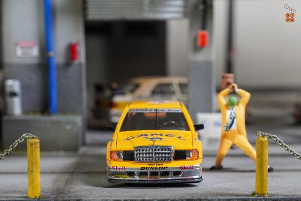 A front side of Mercedes Benz 190E, Camel 1990 Yellow Page livery by LMLF in 1:64 scale with 1:64 figure on AREA 164.