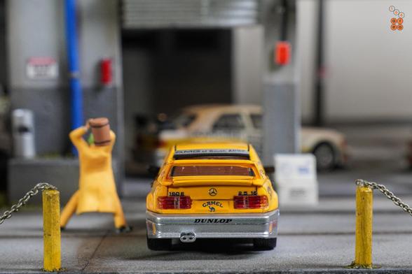 A rear side of Mercedes Benz 190E, Camel 1990 Yellow Page livery by LMLF in 1:64 scale with 1:64 figure on AREA 164.