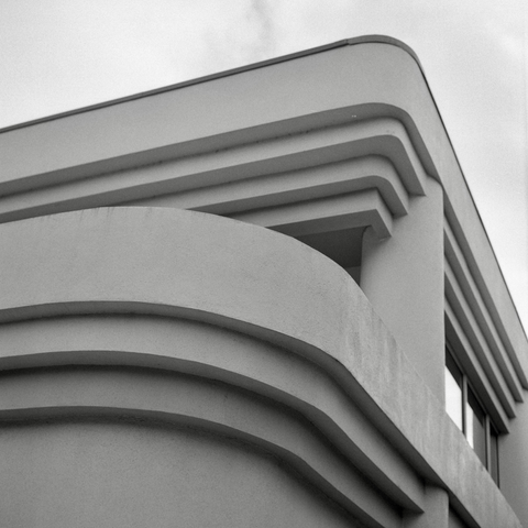 A black-and-white film photo. The fascinating curvy lines of an Art Deco building in downtown Austin, Texas. Sunday, November 16, 2025.