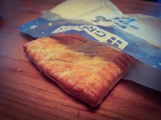 A beautiful looking Greggs Steak Bake, sticking out of a paper packet
