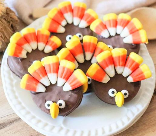 Special cookie and candy treats shaped and decorated like little turkeys on a white plate