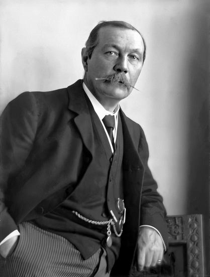 Arthur Conan Doyle  in 1914

by Walter Benington 

Conan Doyle is seen from the chest up, seated and angled slightly to his left while looking directly at the camera.

He wears a dark suit with a high-collared shirt and tie, and his neatly groomed mustache is prominent. His hair is combed back, and the lighting highlights the contours of his face.

https://en.wikipedia.org/wiki/Arthur_Conan_Doyle#/media/File:Arthur_Conan_Doyle_by_Walter_Benington,_1914.png