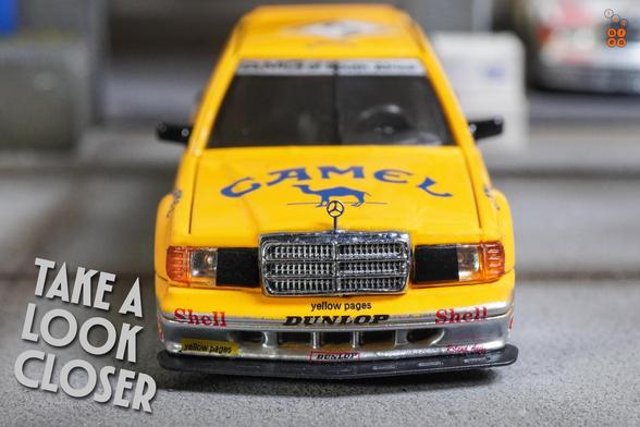 A close-up shot of Mercedes Benz 190E, Camel 1990 Yellow Page livery by LMLF in 1:64 scale on AREA 164.