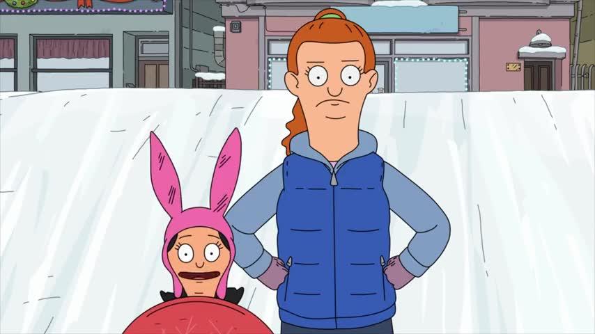 Louise and an older girl look toward the bottom of a sledding hill.