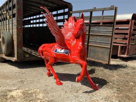 Front three-quarter view of the sculpture in front of horse trailer 