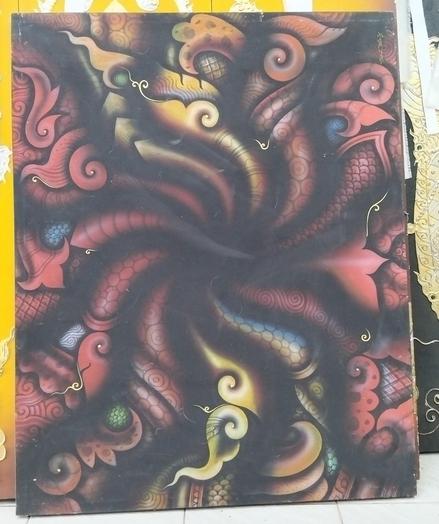 a painting, it is a swirling design with thai traditional design elements, it is mostly red with gold and some blue , twisting shapes coming from the center 
