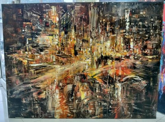 another blurred cityscape painting, energy whirling from the center of it, it is tinted amber 