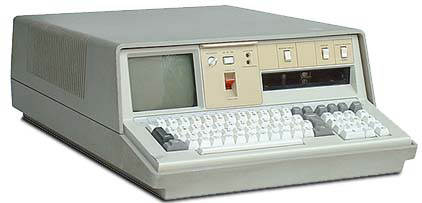 IBM 5100 Portable Computer, three-quarters view from above front left. The screen is off and there is no QIC cassette in the tape slot. 