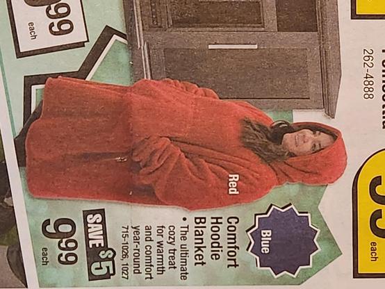 Newspaper ad clipping of a woman cloaked in a Red Comfort Hoodie Blanket priced Save $5 @ 9.99