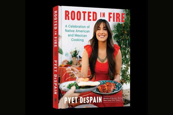 Cover of the cookbook Rooted in Fire by Pyet Despain. The front shows Despain smiling while holding a plate of food outdoors, wearing a red dress and turquoise necklace. The subtitle reads, “A Celebration of Native American and Mexican Cooking,” and the spine features the book title and author’s name.