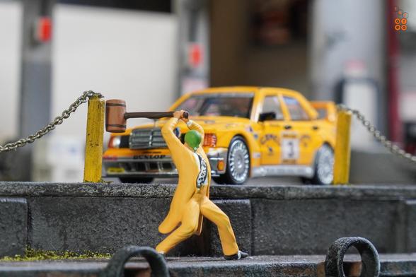 The Mask and a Mercedes Benz 190E 2.5-1.6 Evolution II, Camel 1990 Yellow Page livery by LMLF in 1:64 scale with 1:64 figure on AREA 164