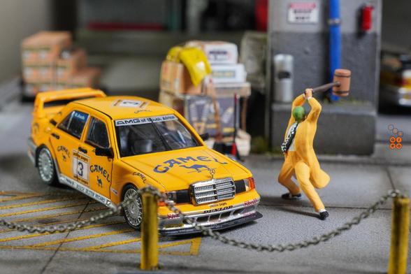 The Mask and a Mercedes Benz 190E 2.5-1.6 Evolution II, Camel 1990 Yellow Page livery by LMLF in 1:64 scale with 1:64 figure on AREA 164