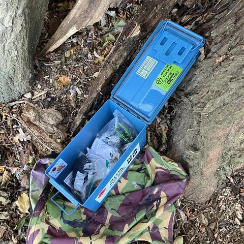 Large metal ammo can geocache containing lots of goodies to swap as well as the logbook to sign. 