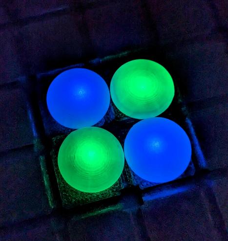 4 glowing Go stones, 2 green and 2 blue