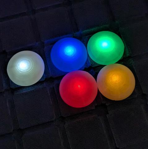5 glowing Go stones: white, blue, green, red, orange