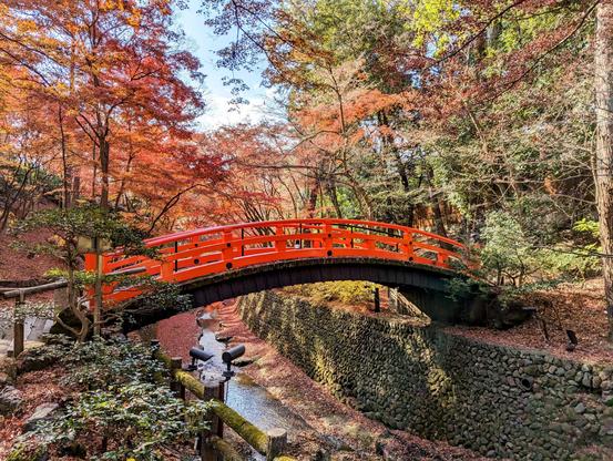 The Uguisu-bashi, a vermillion arched bridge that crosses the Tenjin-gawa river beneath Kitano Tenmangu.