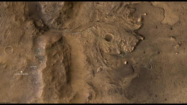 A map of the west side of Jezero Crater on Mars. The delta of the Neretva river and the wall of the rim of Jezero Crater are particularly prominent. The path and stations of the Perseverance rover since landing are indicated. The Sol 1699 present location is marked by a cross and labelled. The location of the next major science target, named Lac de Charmes by the mission team, is pinpointed and labelled.