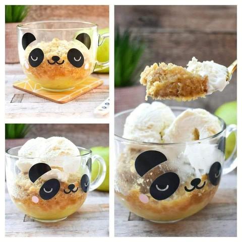 Apple crumble (crisp) topped with vanilla ice cream in a glass mug with a panda face.