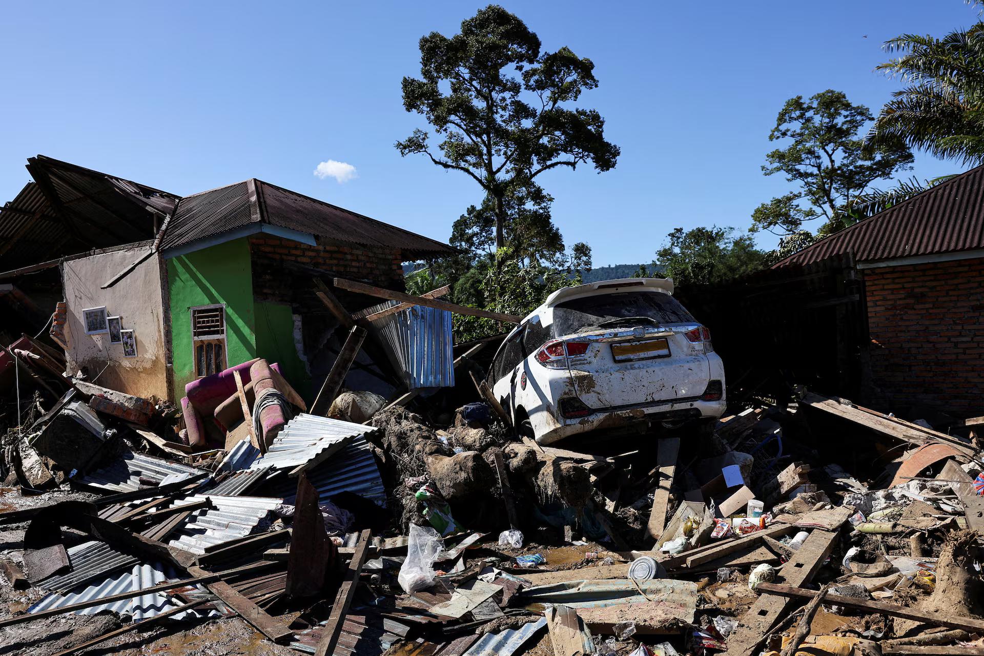 A car sits stuck among rubble at an area hit by deadly flash floods.