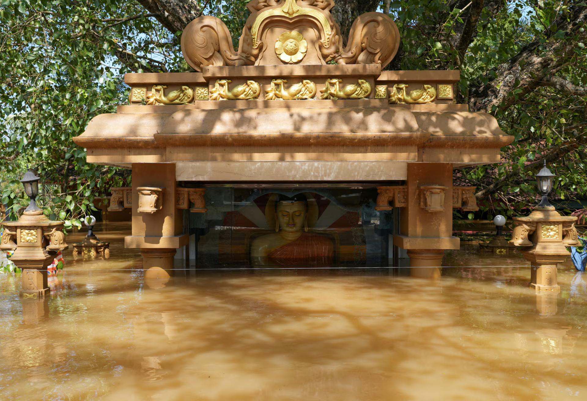 A partially submerged statue of Buddha in a flooded area, following Cyclone Ditwah in Kelaniya, Sri Lanka.