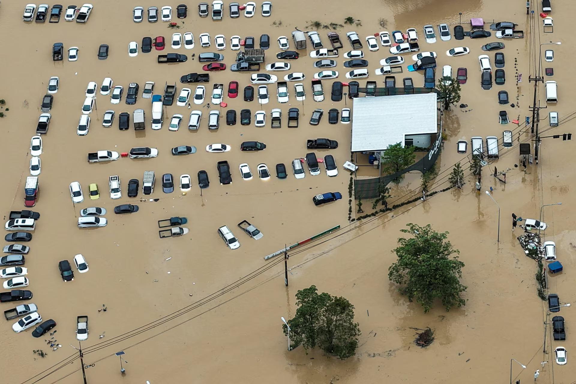 A drone view shows cars parked in a flooded area.