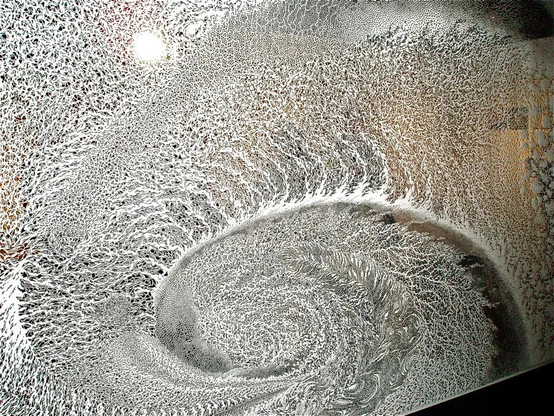 An intricate, large-scale paper cut tapestry by Japanese artist Tomoko Shioyasu, featuring dense, organic patterns resembling the flow of water or cellular structures. 