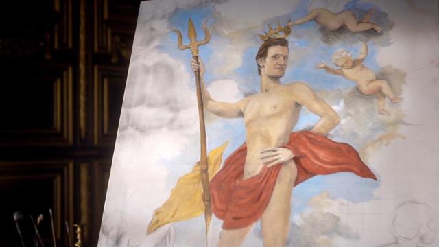 Matt Smith episode. Inside an old English castle, closeup of an oil painting of the Doctor naked, a red cloth flowing around his waist but leaving a lot to look at, holding a gold trident and wearing a gold crown, two naked babies flying in the sky and clouds that surround him. No caption.