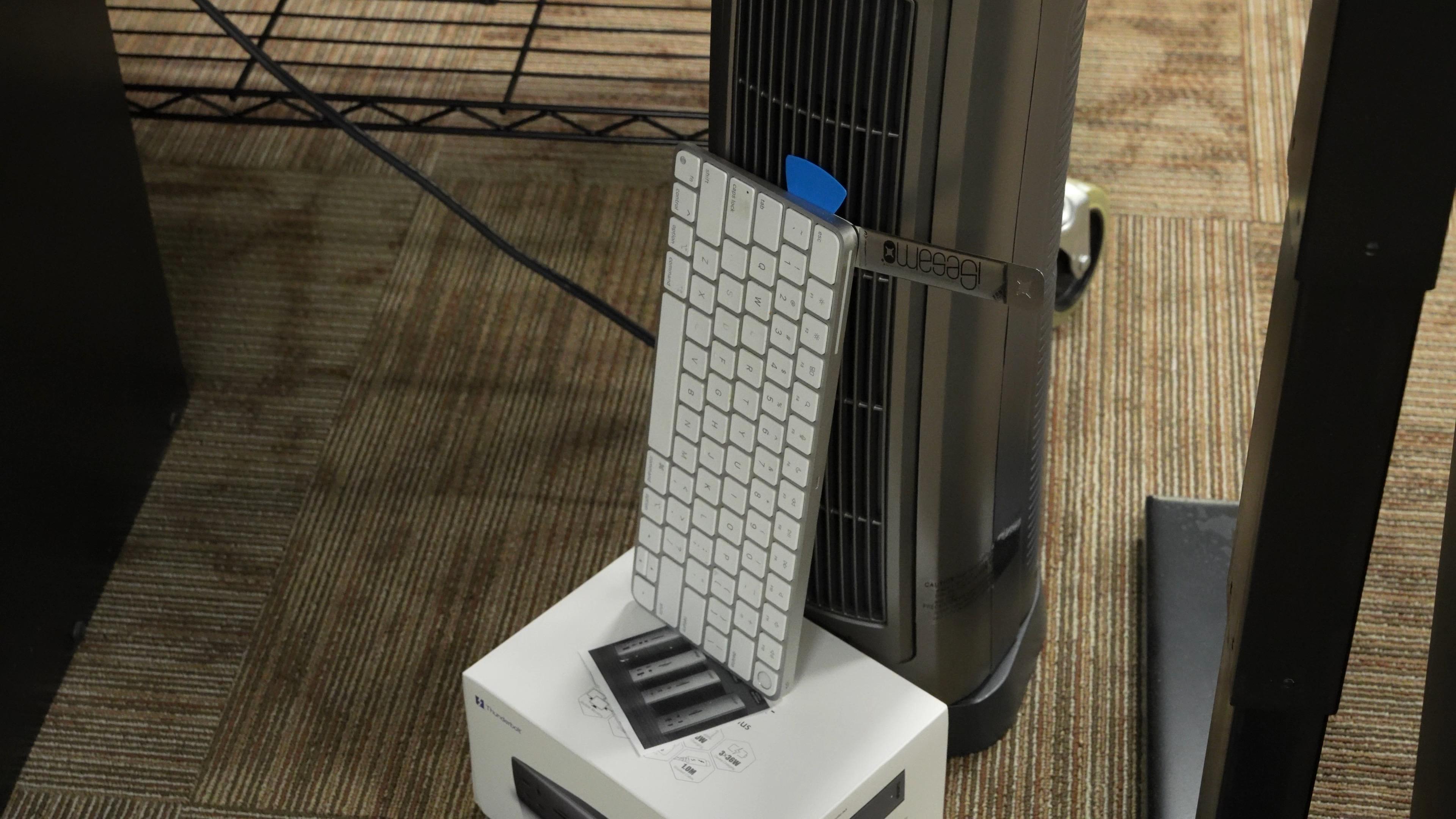 Apple keyboard leaning against a space heater