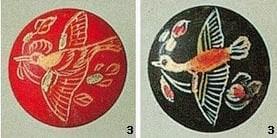 Examples of ancient Korean Go stones. One is red and the other is black. Both depict birds.