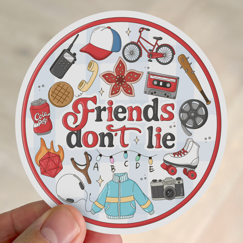 A round sticker features the phrase “Friends don't lie” surrounded by nostalgic 80s icons: cassette tape, bicycle, walkie-talkie, roller skate, and cola can.