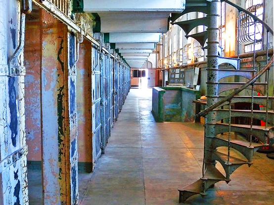 Alcatraz Island is a small island 1.25 miles offshore from San Francisco, California, United States. The island was developed in the mid-19th century with facilities for a lighthouse, a military fortification, and a military prison. In 1934, the island was converted into a federal prison, Alcatraz Federal Penitentiary. The prison closed in 1963.