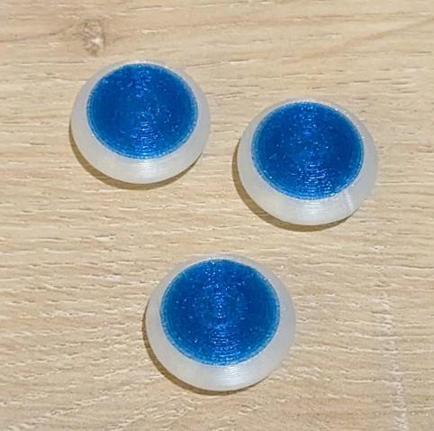 3D printed Go stones upside down showing a blue bottom surface.