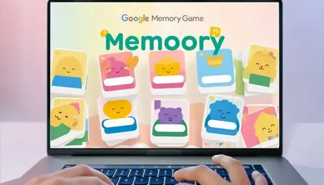 "Person playing the Google Memory Game on a laptop screen displaying colorful memory cards with cute character icons."