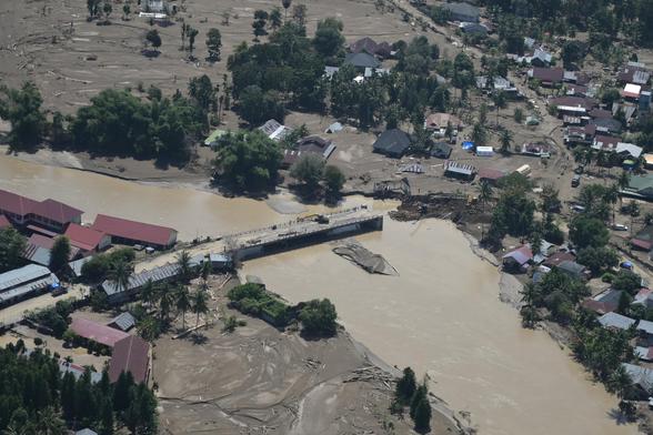 An area affected by floods in #Aceh province, with a broken bridge and flooded houses.
