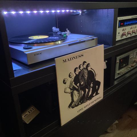 A photo of the album cover and the record playing. 