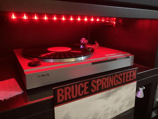 The album cover. The album playing on a turntable. 