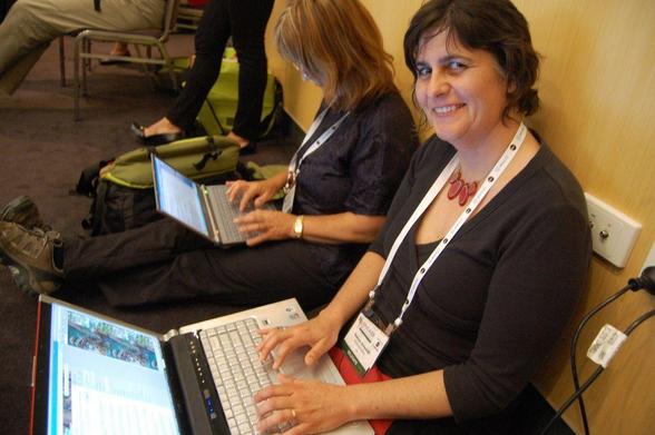 live blog a public conference: photograph of a conference participant blogging on their computer. Photo attribution: Flickr user catspyjamasnz