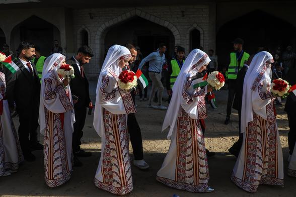 Palestinian grooms and brides gather for the mass wedding in Khan Younis.