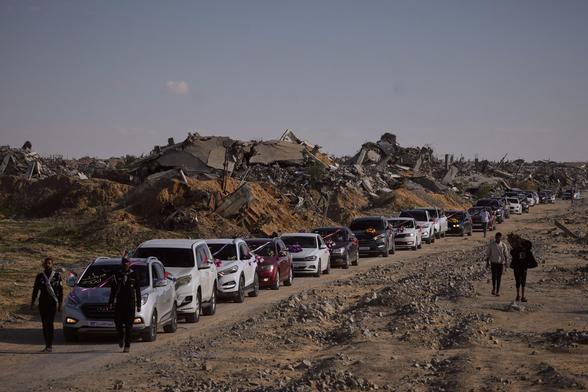 A convoy of Palestinian grooms travel to Hamad City in Khan Yunis before the ceremony across a devastated landscape of flattened buildings.