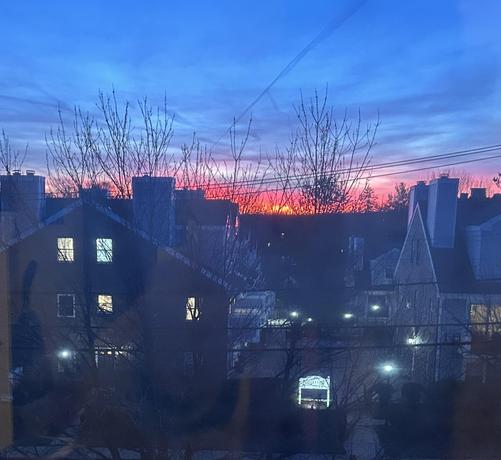 Pink sky..
Dim sunset . Sky Colors are pink and dark blue with the skyline of the houses.