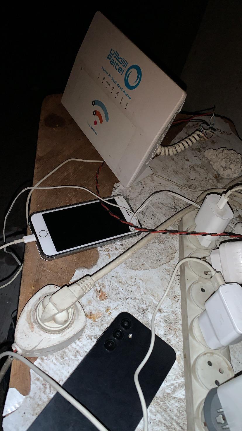 A phone charging next to a WiFi emitter