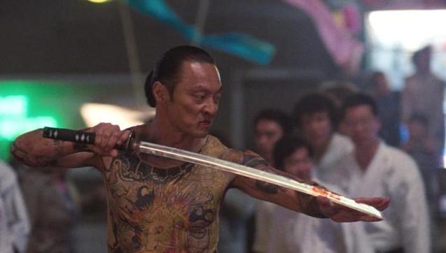 Japanese-born actor and film producer Cary-Hiroyuki Tagawa as leader of The Iron Claw gang, Funekei Yoshida in the 1991 American buddy cop action film “Showdown in Little Tokyo” . He’s shirtless and his upper body is covered in intricate tattoos. He’s wearing a traditional Japanese undergarment called a Fundoshi while handling a slightly bloodied sword.
