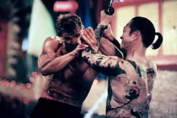 Japanese-born actor and film producer Cary-Hiroyuki Tagawa as leader of The Iron Claw gang, Funekei Yoshida in the 1991 American buddy cop action film “Showdown in Little Tokyo” . He’s shirtless and his upper body is covered in intricate tattoos. He’s wearing a traditional Japanese undergarment called a Fundoshi while fighting shirtless, Swedish actor, filmmaker, and martial artist Dolph Lundgren in a scene.