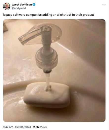 A tweet from @andyreed: “legacy software companies adding an ai chatbot to their product .”The image is a broken soap dispenser pump sitting in a puddle of soap on a bathroom sink, used as a humorous metaphor for legacy software companies hastily adding AI features to their products.