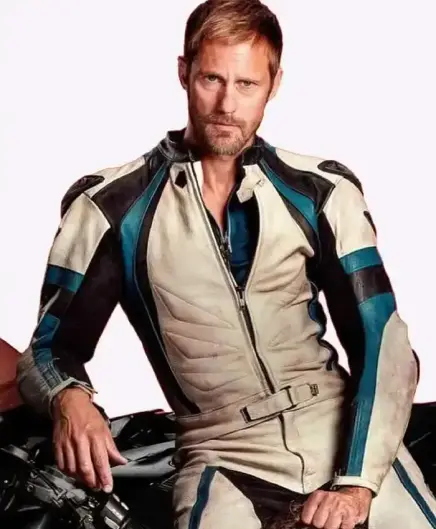Alexander Skarsgård as his character in the movie Pillion wearing a white and slightly smudged leather biker suit from top to buttom with dark and light blue stripes that hug the body. He leans/sits casually against his bike ad looks damn hot! The collar of the suit is open and you see a peek of throat. 