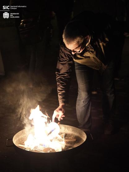 A man lighting his torch.
