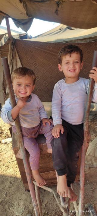 A picture of Sara's two little boys, Yousef (age 3, to the left) and Osama (age 5, to the right). Osama dreams of being blessed with a new red scooter to ride (to replace the one the war destroyed) and to be able to go to kindergarten. Yousef misses his own little bike, also destroyed by the bombings.