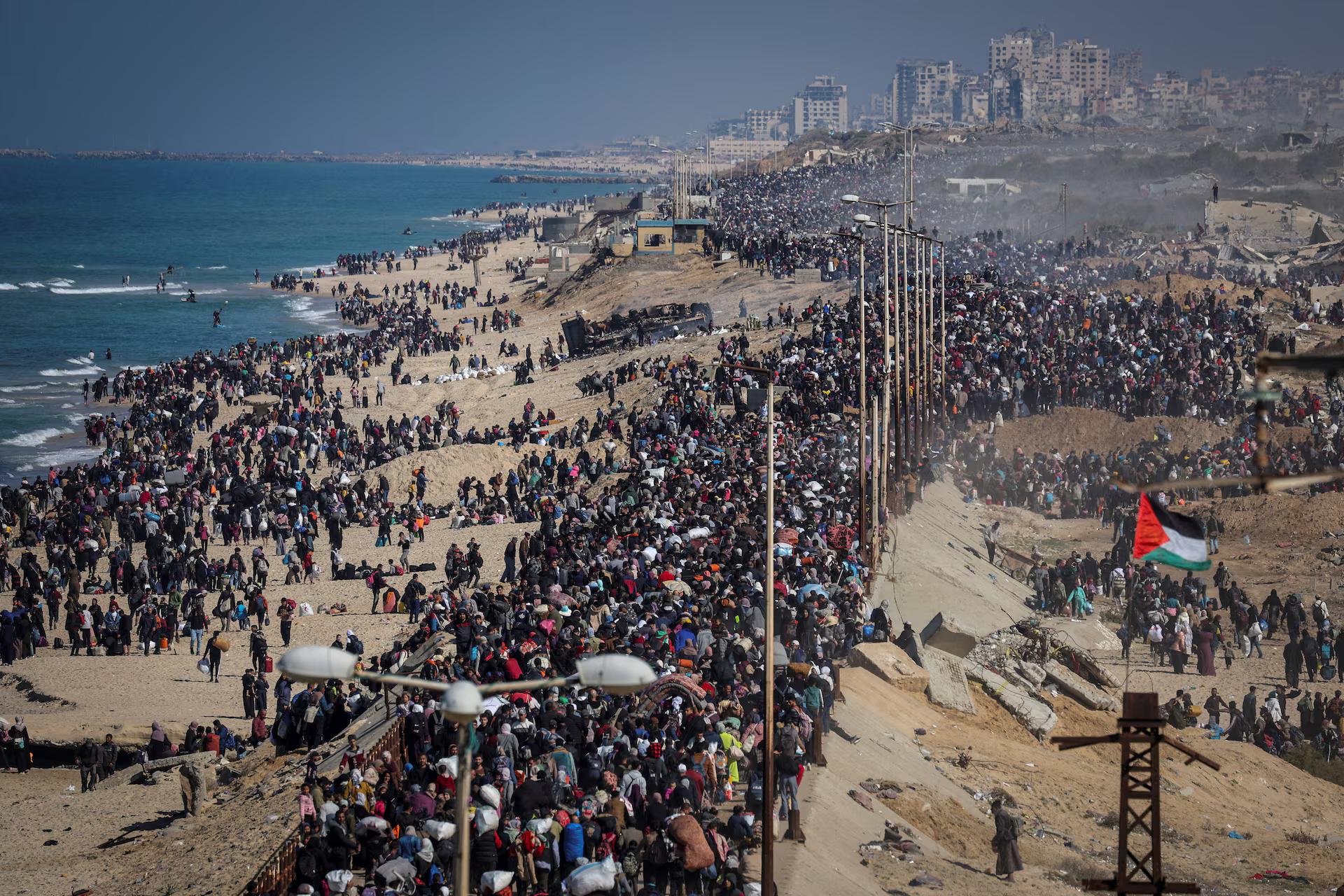 Palestinians, who were displaced to the south at Israel's order during the war, make their way back to their homes in northern Gaza.